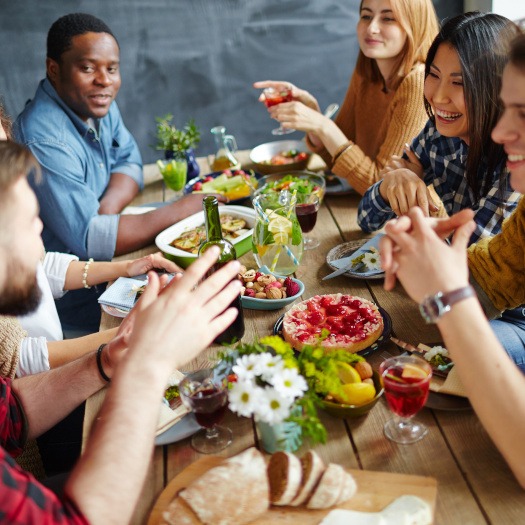 Group of adult friends eating a meal together